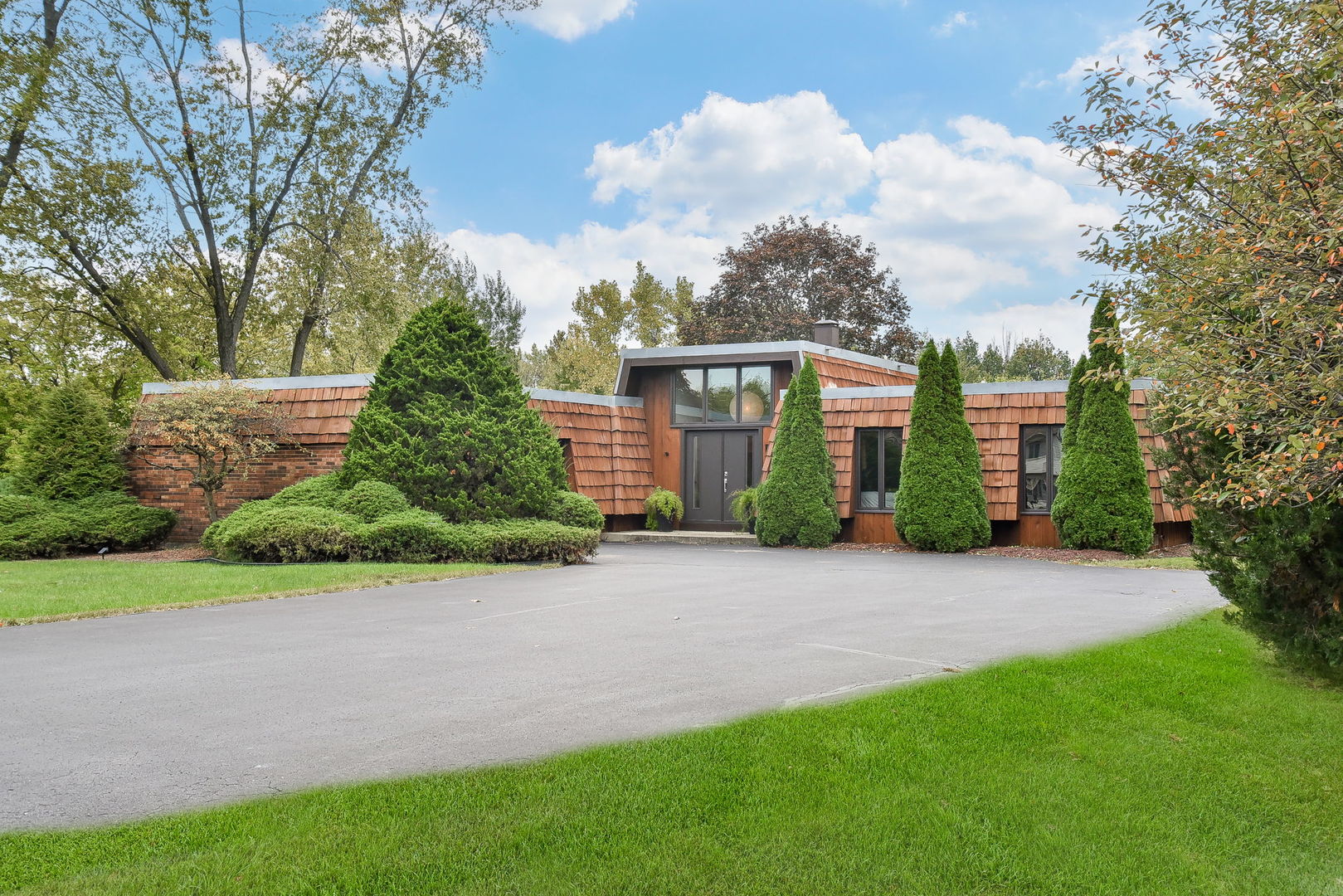 a front view of a house with garden