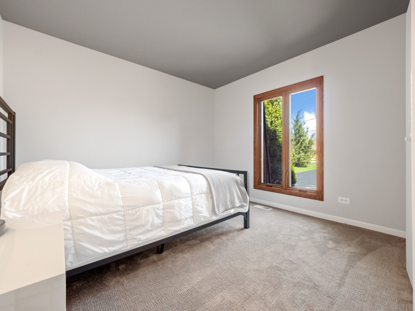 21W741 Bemis Road Glen Ellyn, IL 60137 - Photo 26 of 32 a bed sitting in a bedroom next to a window