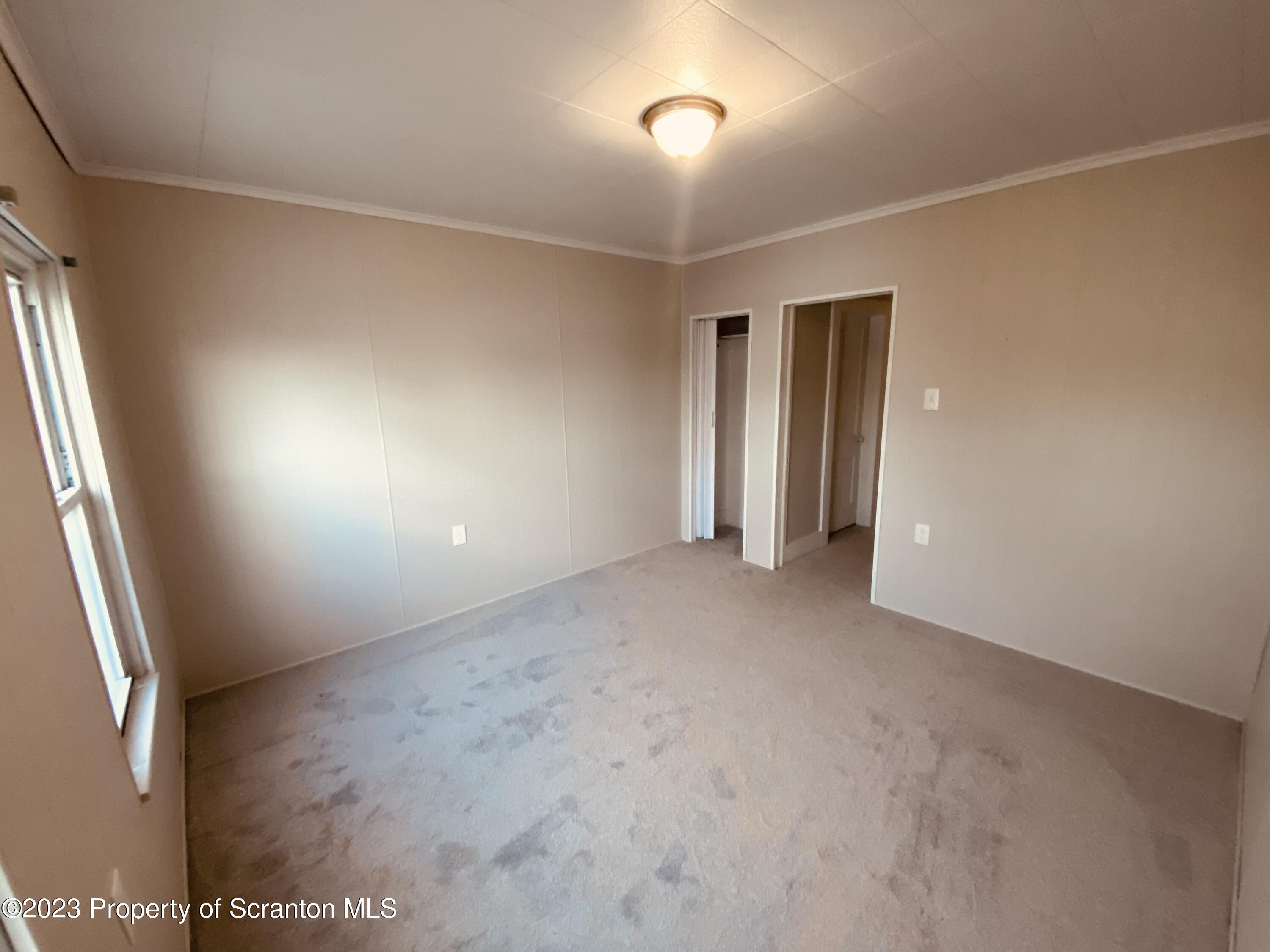 916 South 9th Avenue Scranton, PA 18504 - Photo 16 of 18 an empty room with an entryway and fan