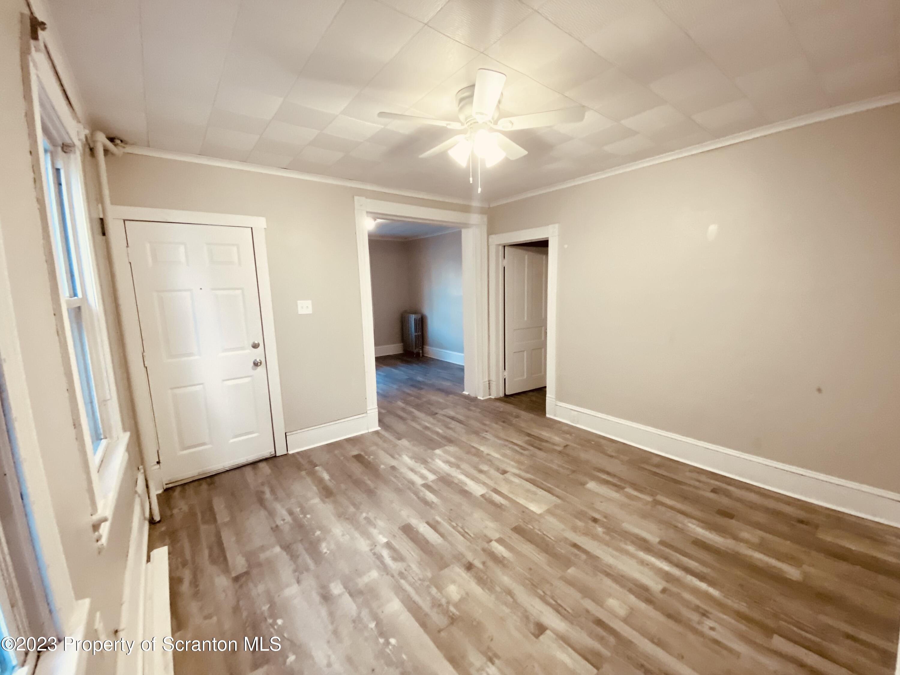 916 South 9th Avenue Scranton, PA 18504 - Photo 3 of 18 a view of an empty room with wooden floor and a window