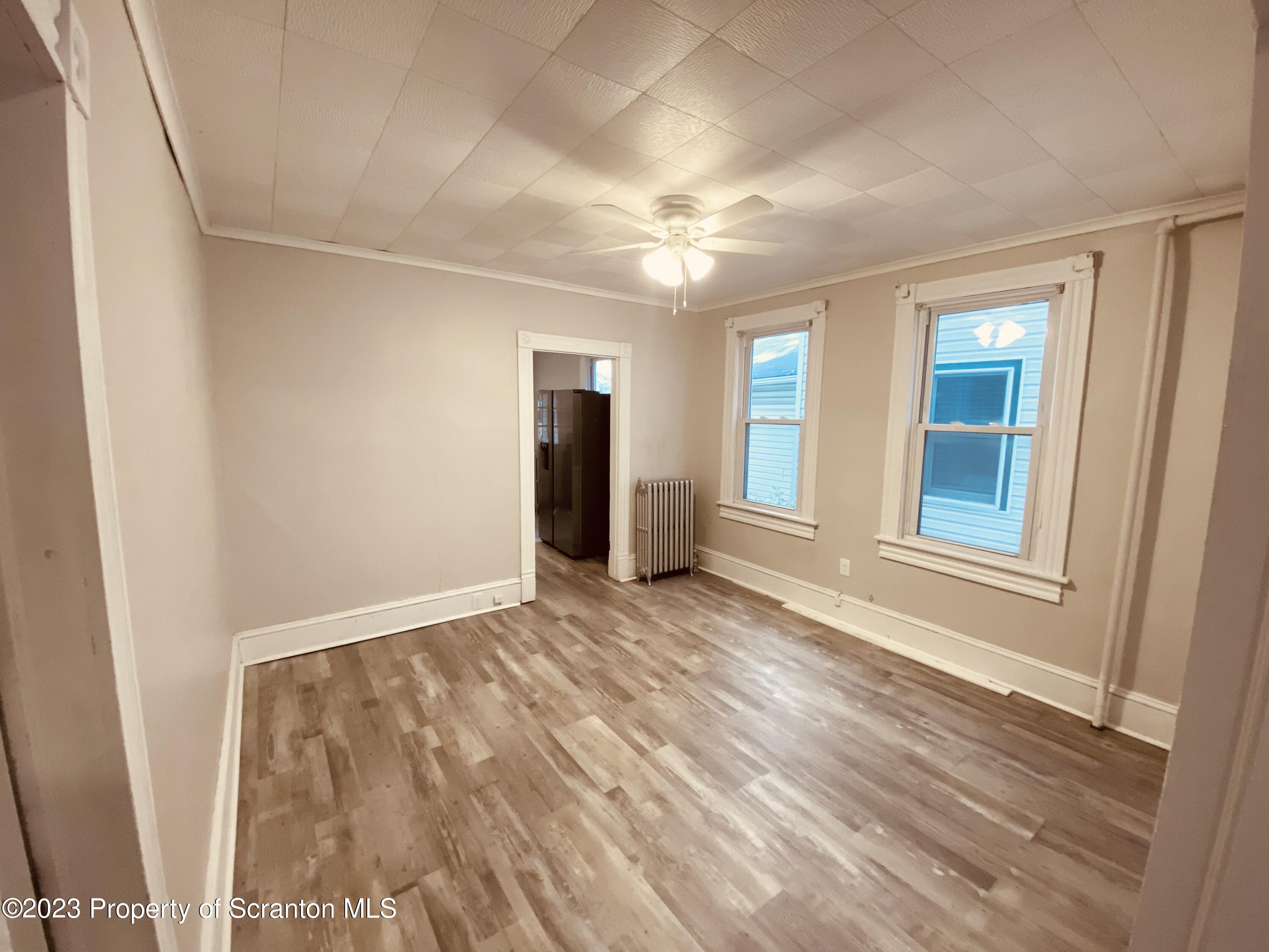 916 South 9th Avenue Scranton, PA 18504 - Photo 4 of 18 a view of an empty room with window and wooden floor