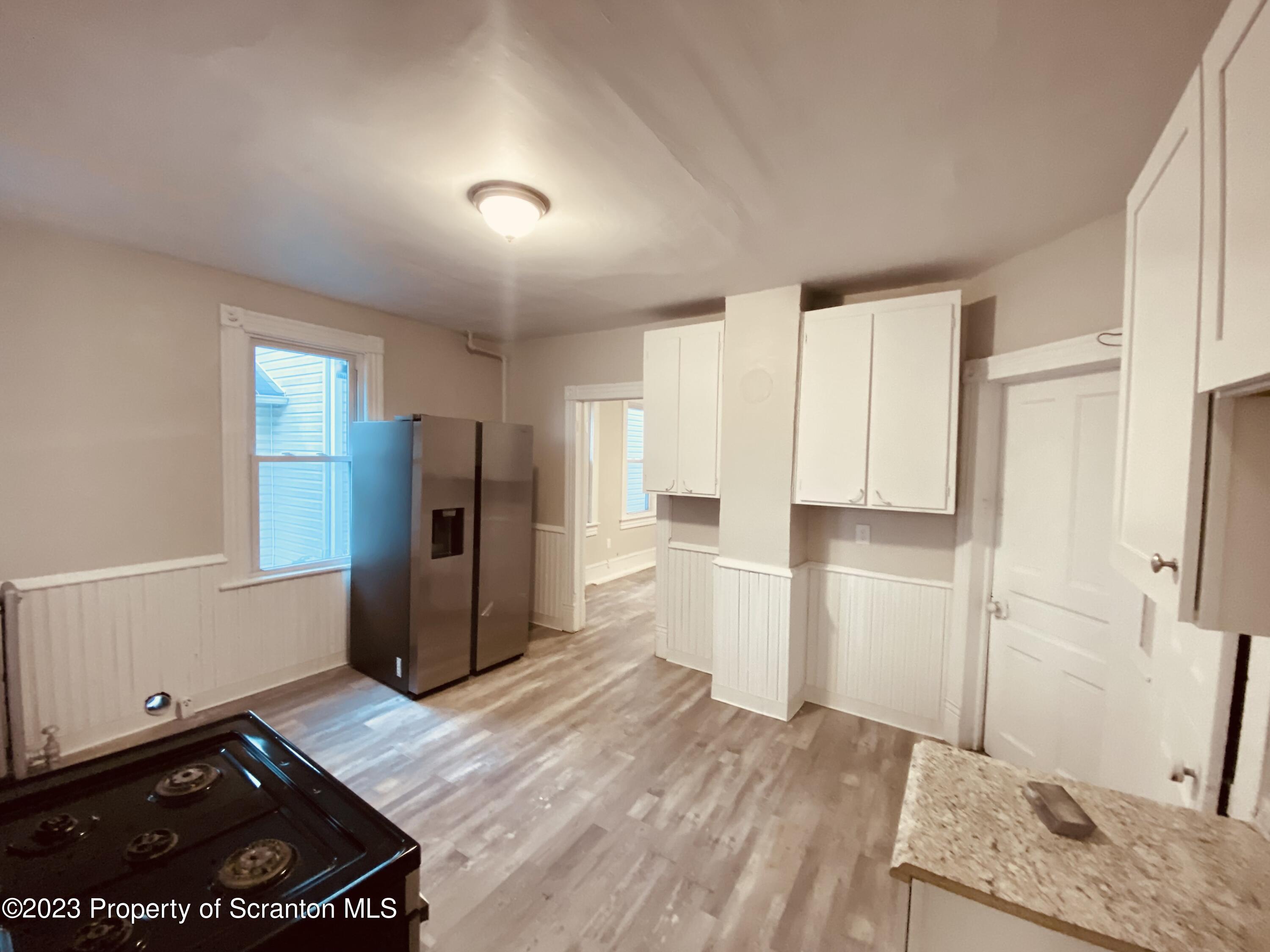 916 South 9th Avenue Scranton, PA 18504 - Photo 8 of 18 a kitchen with a refrigerator and a stove top oven