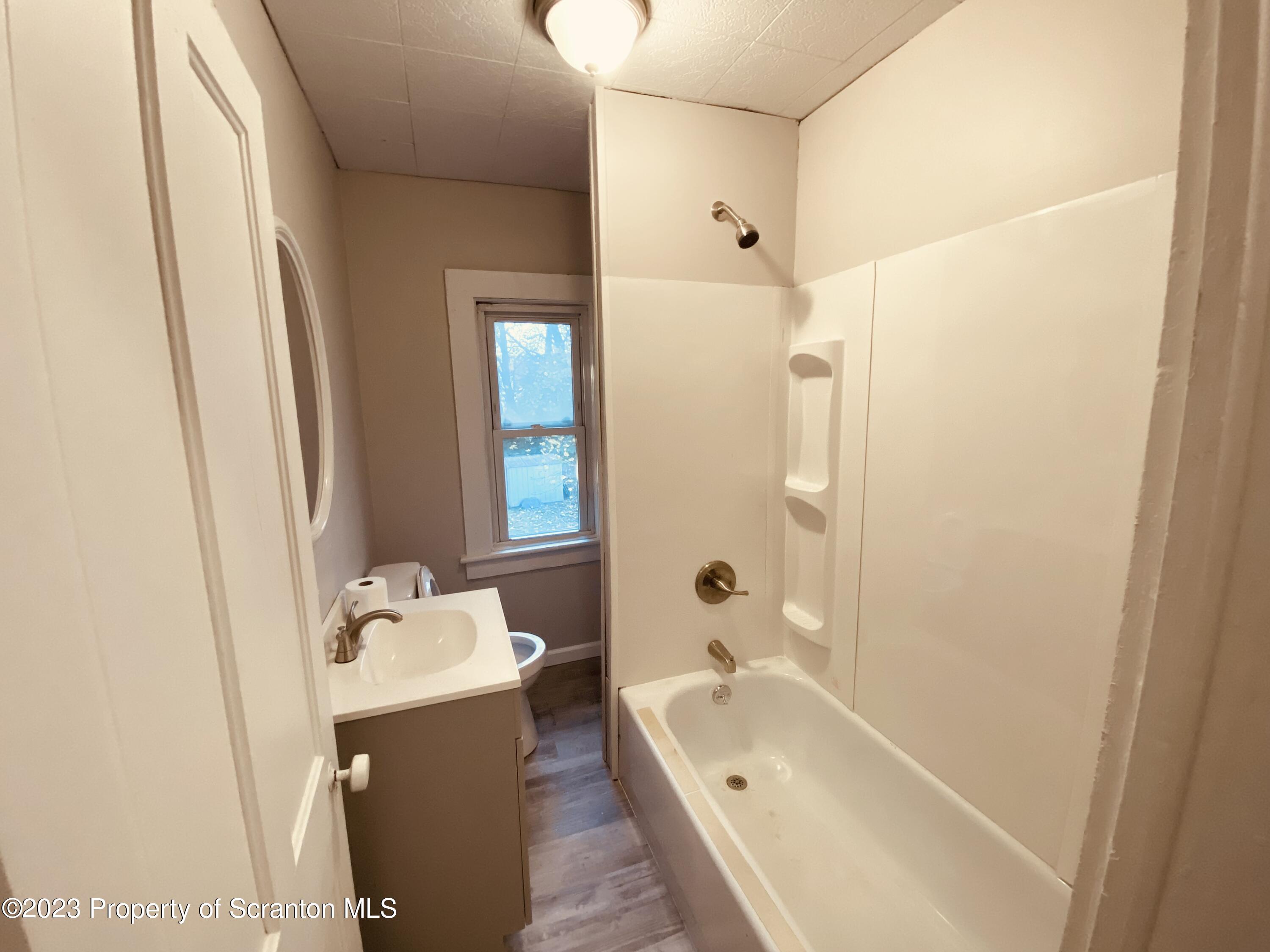 916 South 9th Avenue Scranton, PA 18504 - Photo 10 of 18 a bathroom with a tub sink and mirror