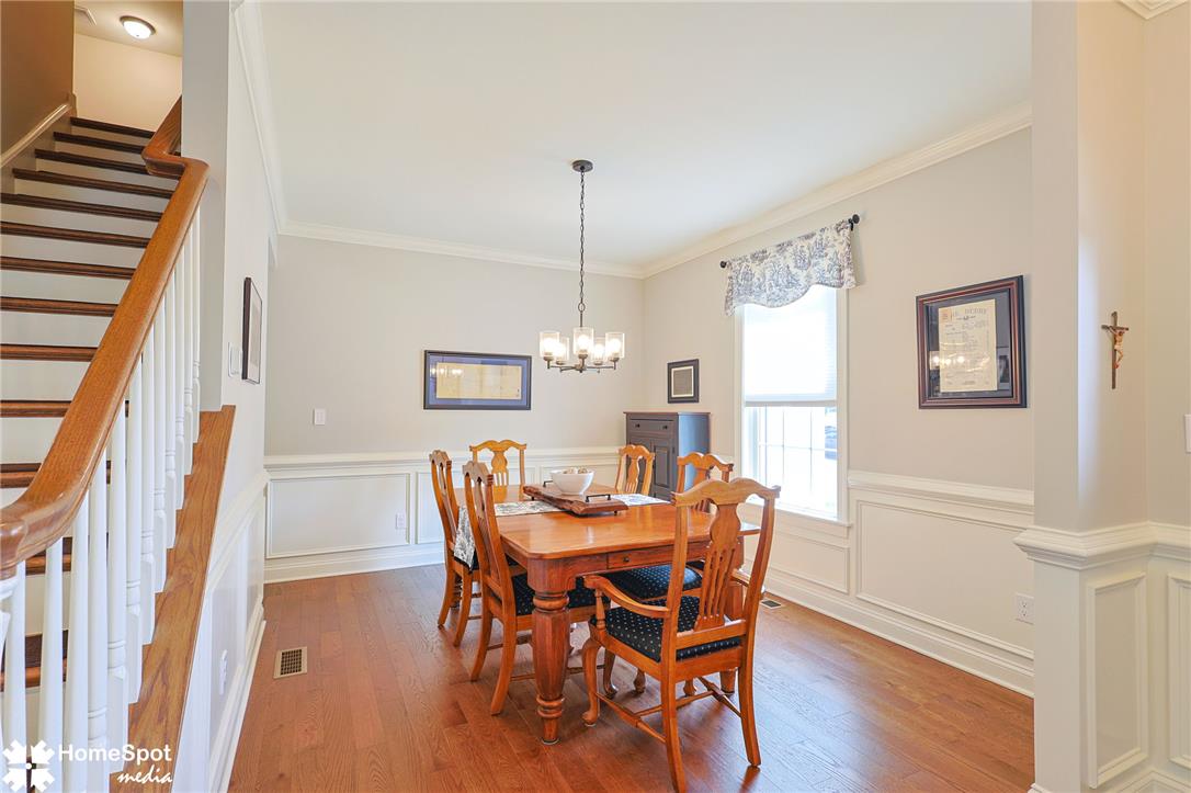 4518 Old Saucon Road Bethlehem, PA 18015 - Photo 11 of 19 Hardwood floors and crisp wainscoting define this formal dining space, complete with a classic chandelier.