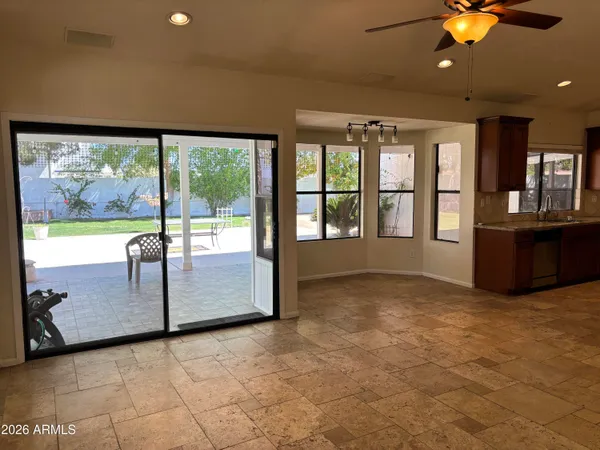 a view of kitchen with stainless steel appliances granite countertop a refrigerator stove top oven and sink