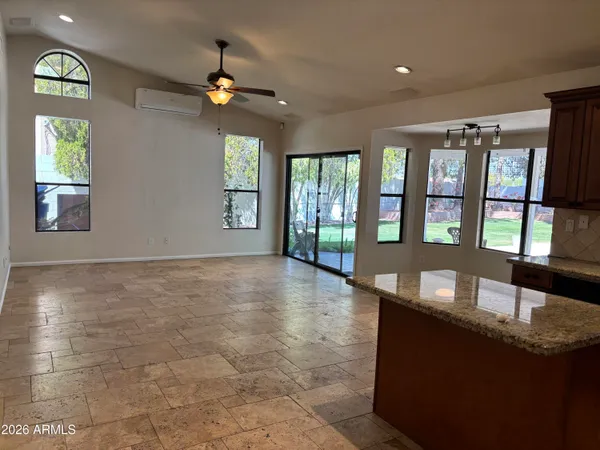 a kitchen with stainless steel appliances granite countertop a stove a sink dishwasher and a refrigerator