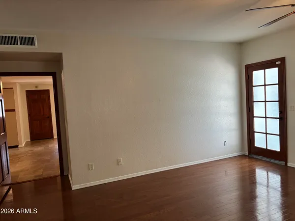 a view of a hallway view with wooden floor and furniture