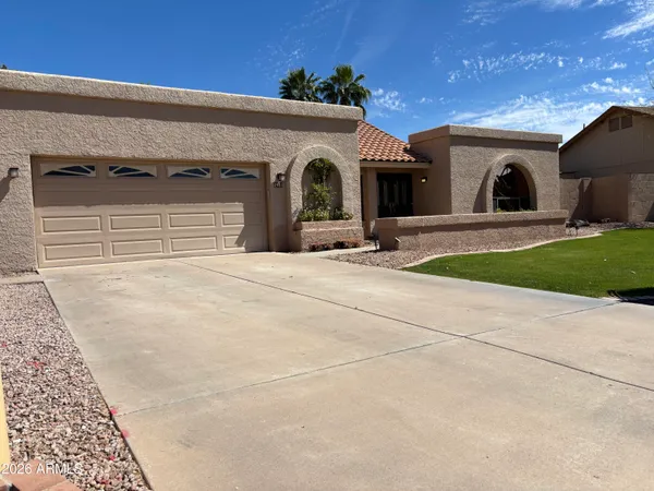 a view of a house with a yard and garage