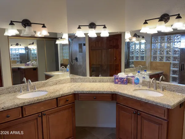 a bathroom with a granite countertop sink and a mirror