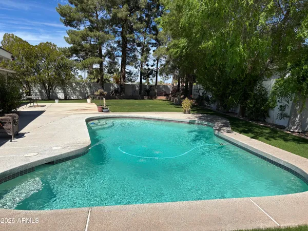 a view of a swimming pool with an outdoor space and seating area
