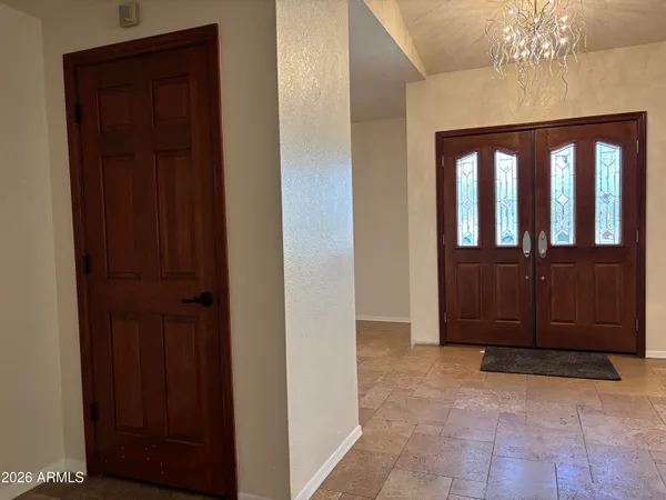 a large kitchen with kitchen island granite countertop a large window and stainless steel appliances