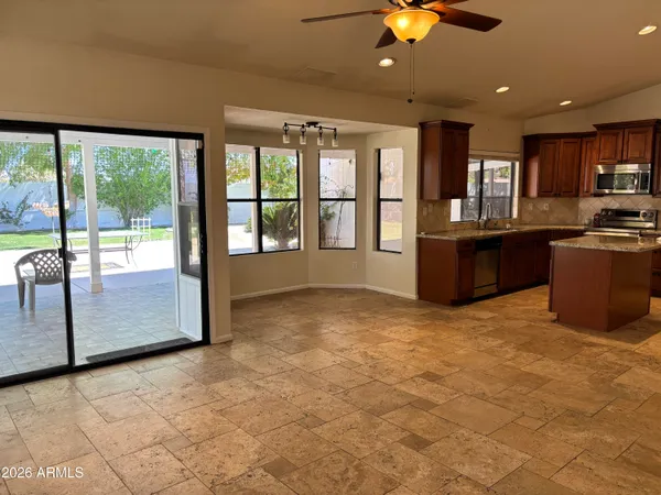 a view of an empty room with a fireplace and windows