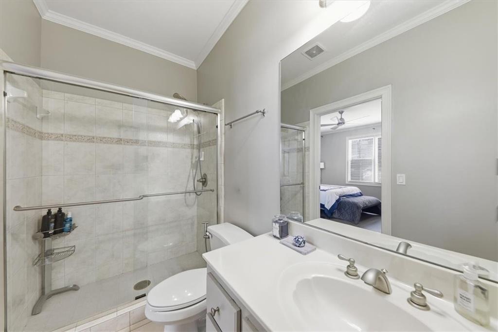 1121 Hiddenbrook Lane Suwanee, GA 30024 - Photo 28 of 42 a bathroom with a sink a toilet and shower