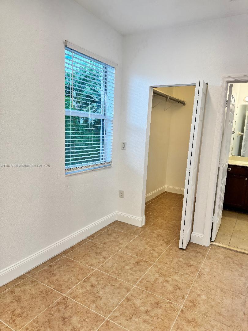 9000 Southwest 169th Avenue, Unit STUDIO Miami, FL 33196 - Photo 5 of 10 a view of an empty room with a window