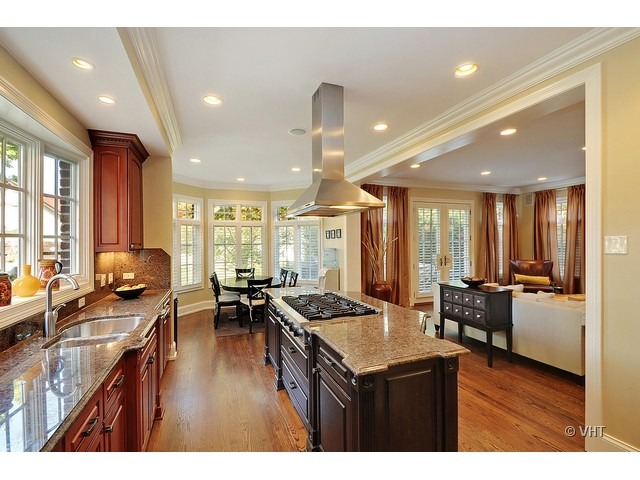 459 Sunset Road Winnetka, IL 60093 - Photo 5 of 16 a kitchen with sink refrigerator and couches with wooden floor