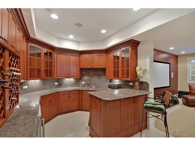 459 Sunset Road Winnetka, IL 60093 - Photo 10 of 16 a kitchen with stainless steel appliances granite countertop a sink a stove counter space and cabinets