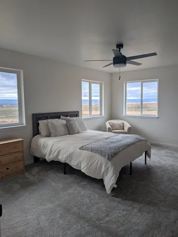 a bed sitting in a bedroom next to a window