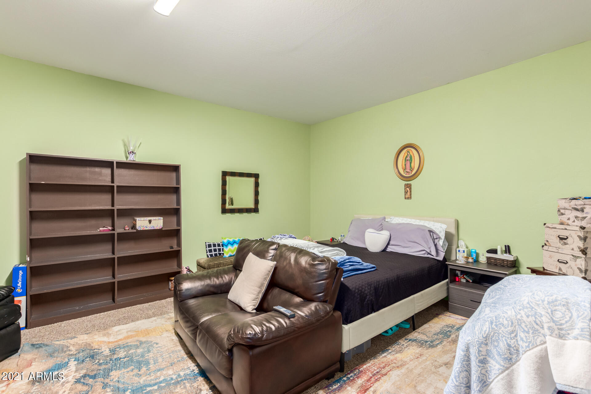 10225 West Camelback Road, Unit 8 Phoenix, AZ 85037 - Photo 16 of 30 a bedroom with a bed and a couch