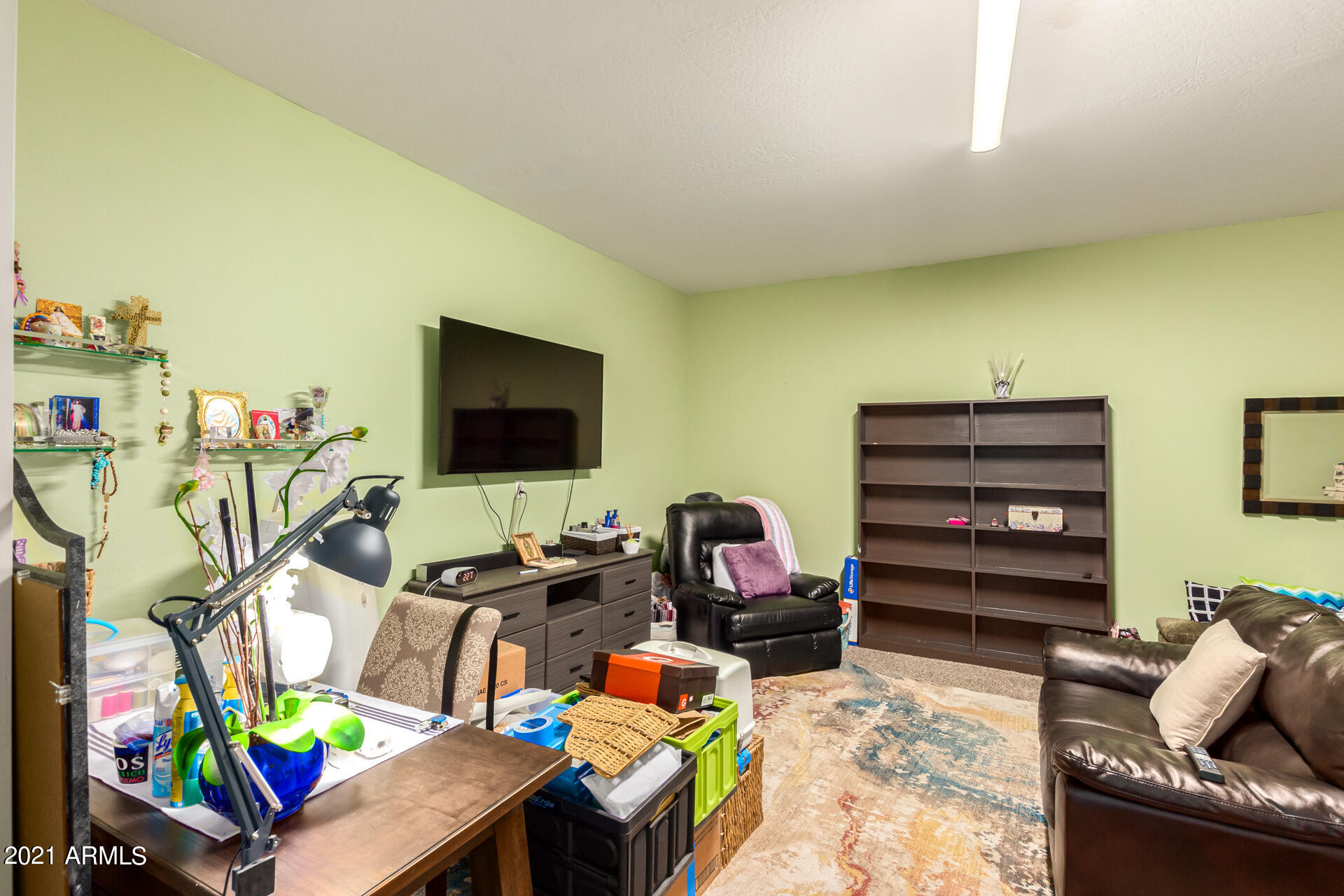 10225 West Camelback Road, Unit 8 Phoenix, AZ 85037 - Photo 17 of 30 a living room with furniture and a flat screen tv