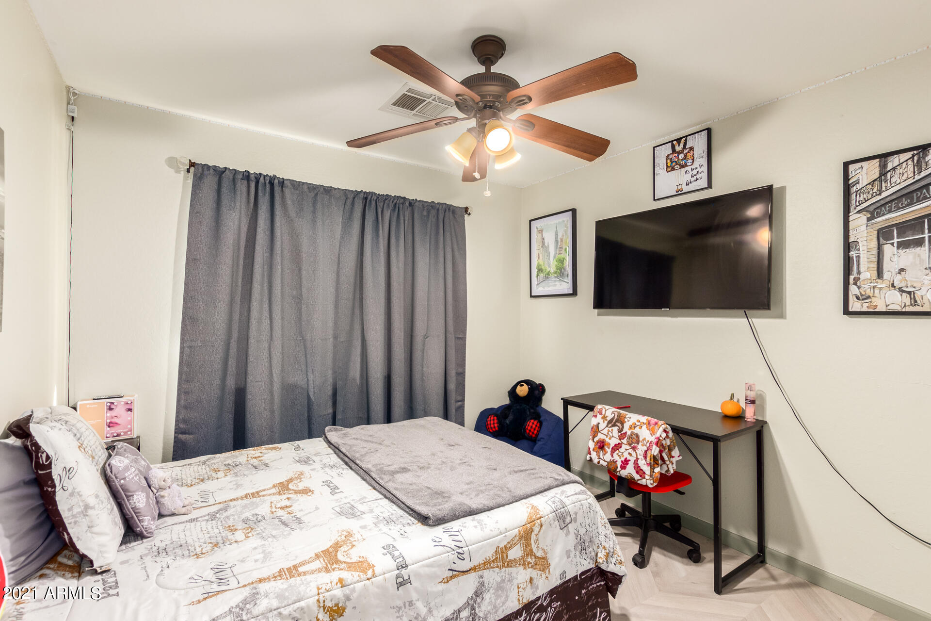 10225 West Camelback Road, Unit 8 Phoenix, AZ 85037 - Photo 19 of 30 a bedroom with a bed and a flat screen tv