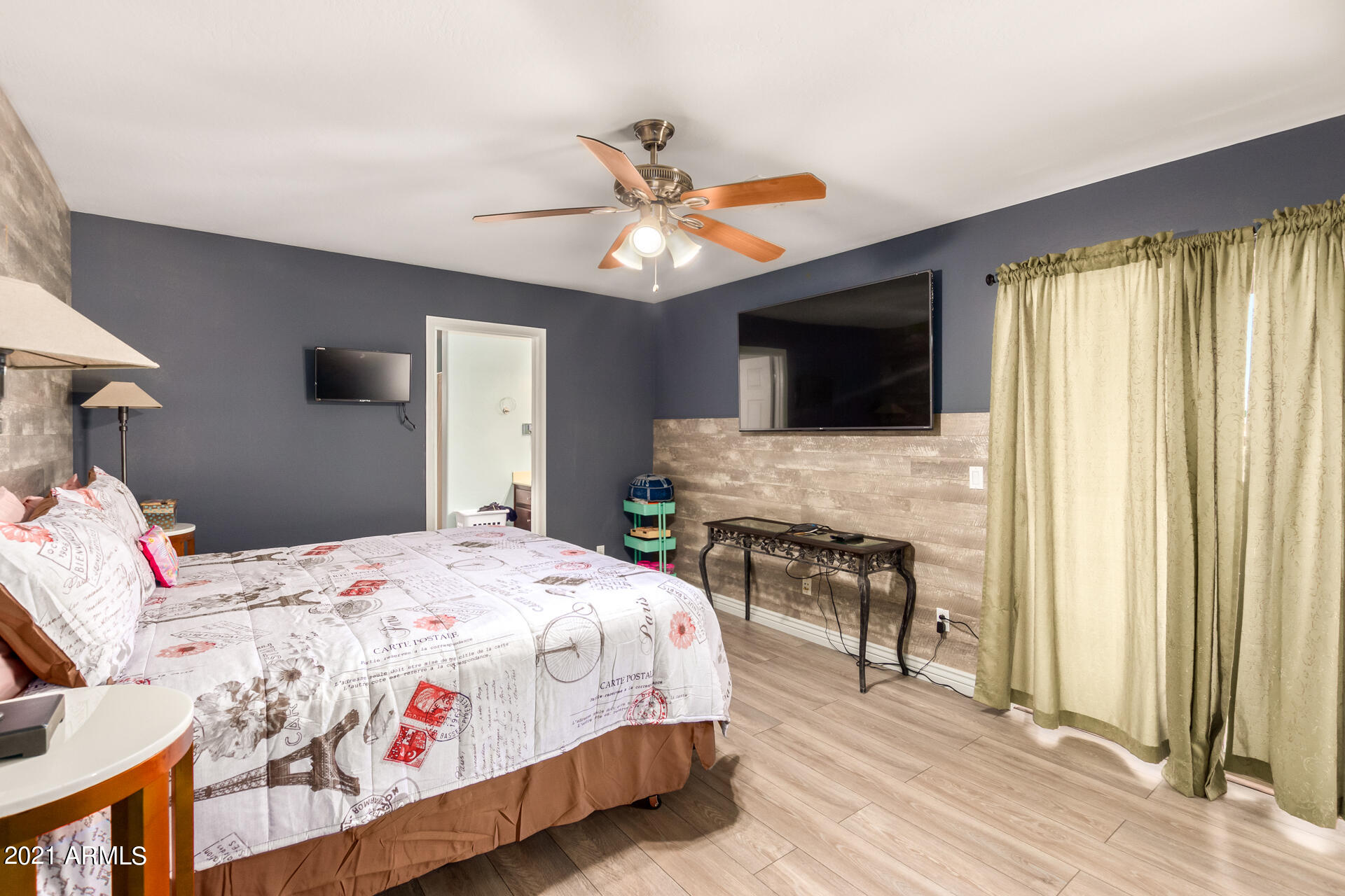 10225 West Camelback Road, Unit 8 Phoenix, AZ 85037 - Photo 21 of 30 a bedroom with a bed and a flat screen tv