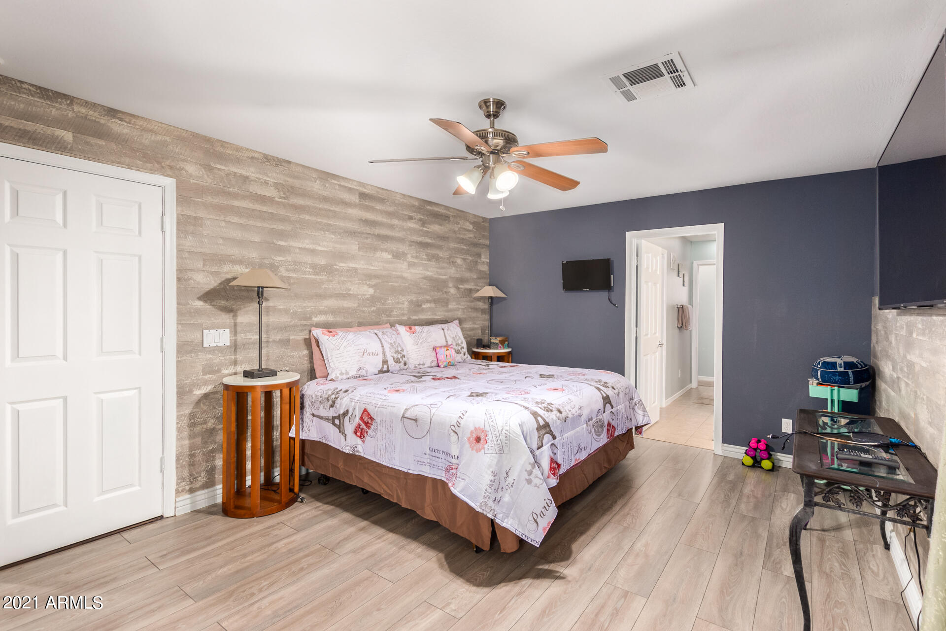 10225 West Camelback Road, Unit 8 Phoenix, AZ 85037 - Photo 22 of 30 a bedroom with a bed and wooden floor