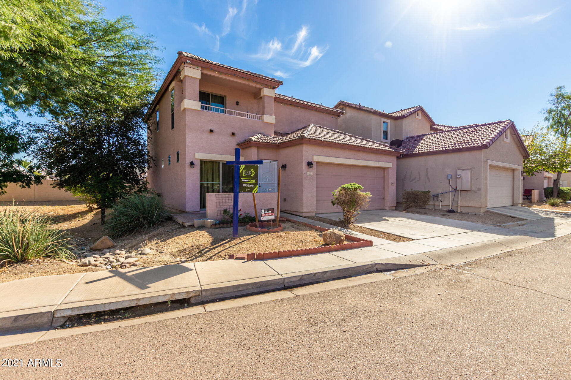 10225 West Camelback Road, Unit 8 Phoenix, AZ 85037 - Photo 3 of 30 a front view of a house with a yard and a garage