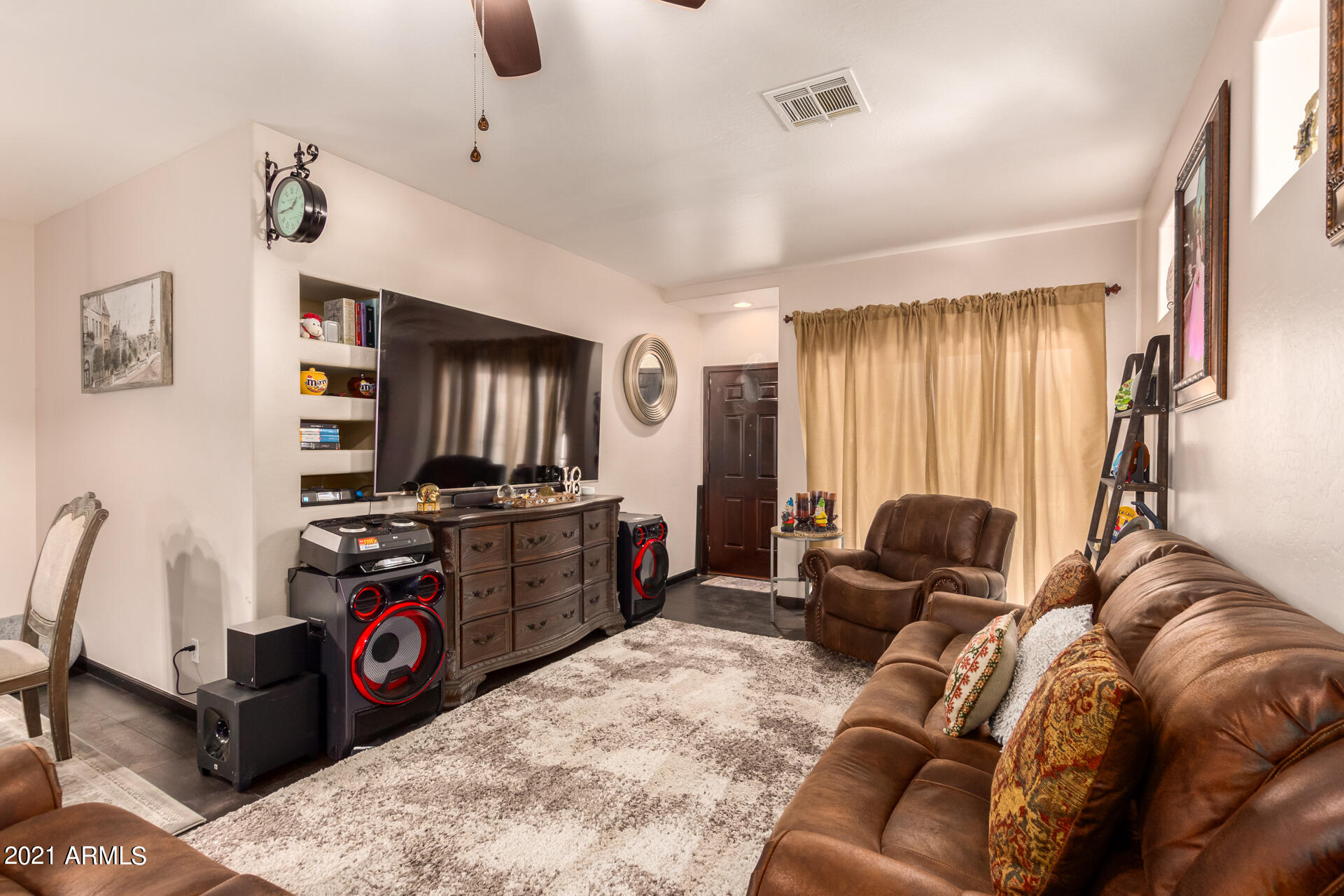 10225 West Camelback Road, Unit 8 Phoenix, AZ 85037 - Photo 6 of 30 a living room with furniture a flat screen tv and a window