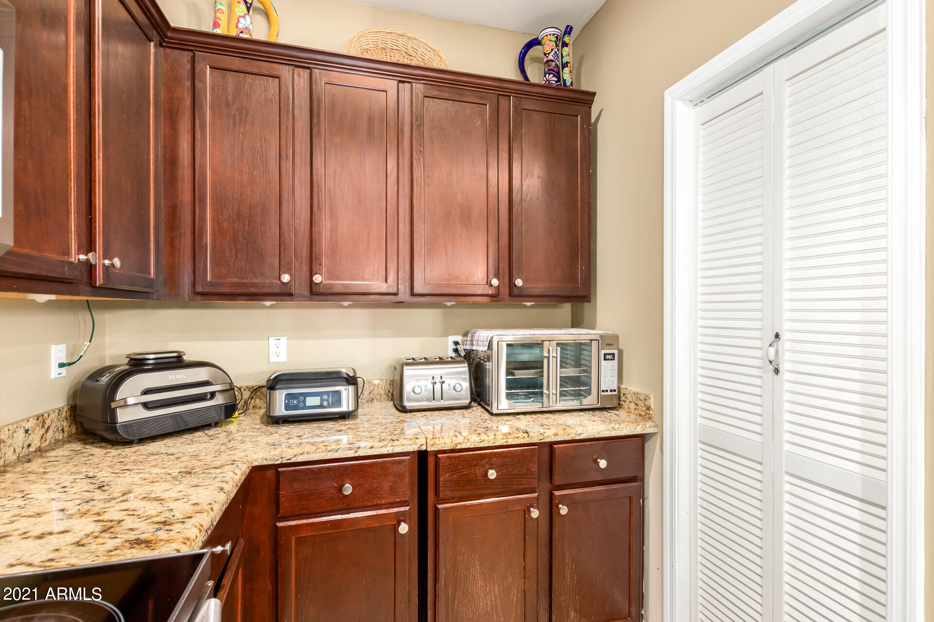 10225 West Camelback Road, Unit 8 Phoenix, AZ 85037 - Photo 10 of 30 a kitchen with granite countertop a sink a stove and cabinets