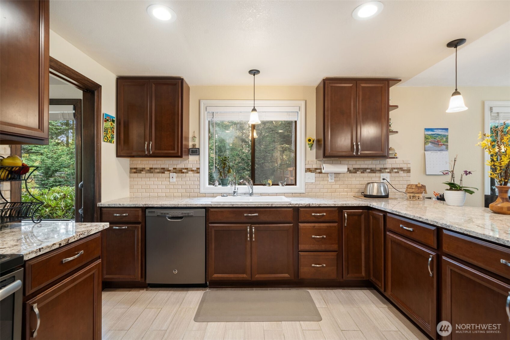 383 Kirner Road Sequim, WA 98382 - Photo 12 of 40 a kitchen with a sink stove and cabinets