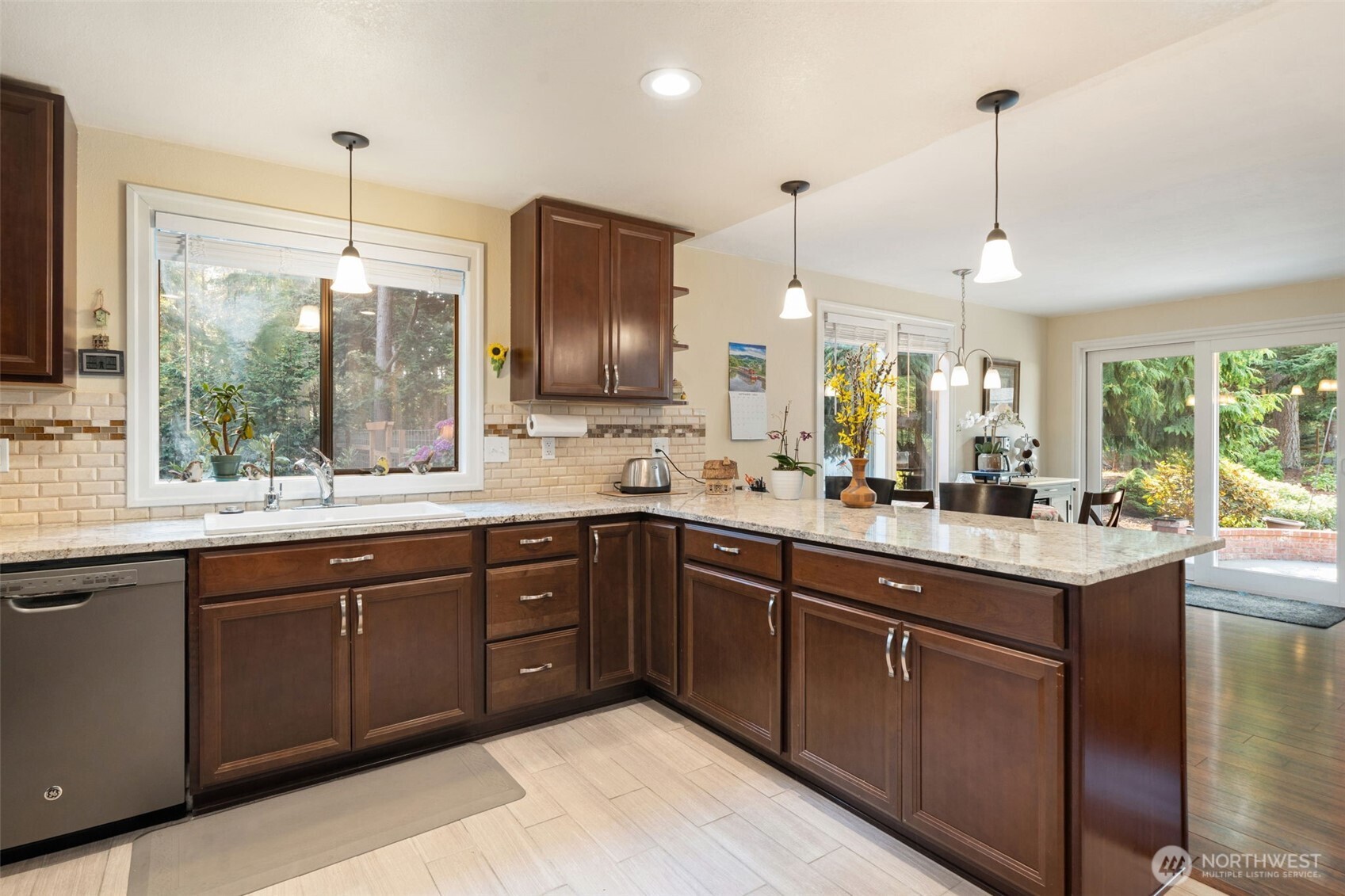 383 Kirner Road Sequim, WA 98382 - Photo 13 of 40 a kitchen with sink cabinets and window