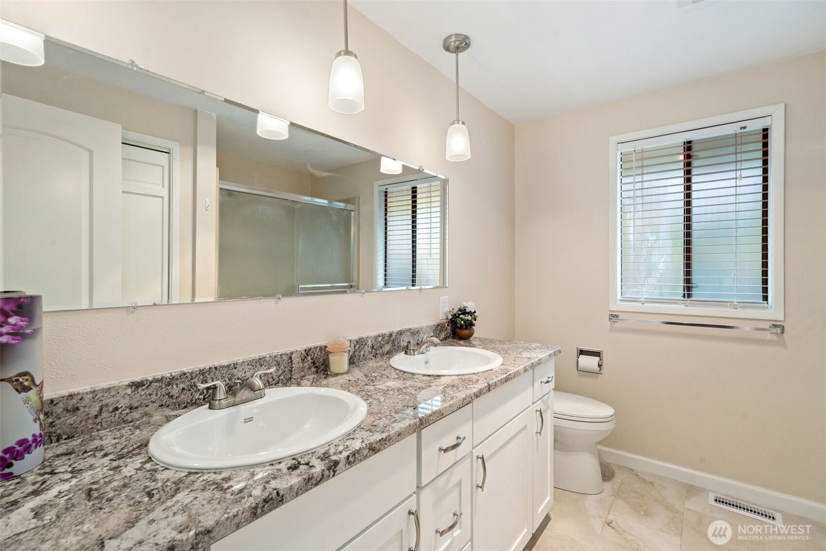383 Kirner Road Sequim, WA 98382 - Photo 19 of 40 a bathroom with a granite countertop double vanity sink a mirror and a toilet