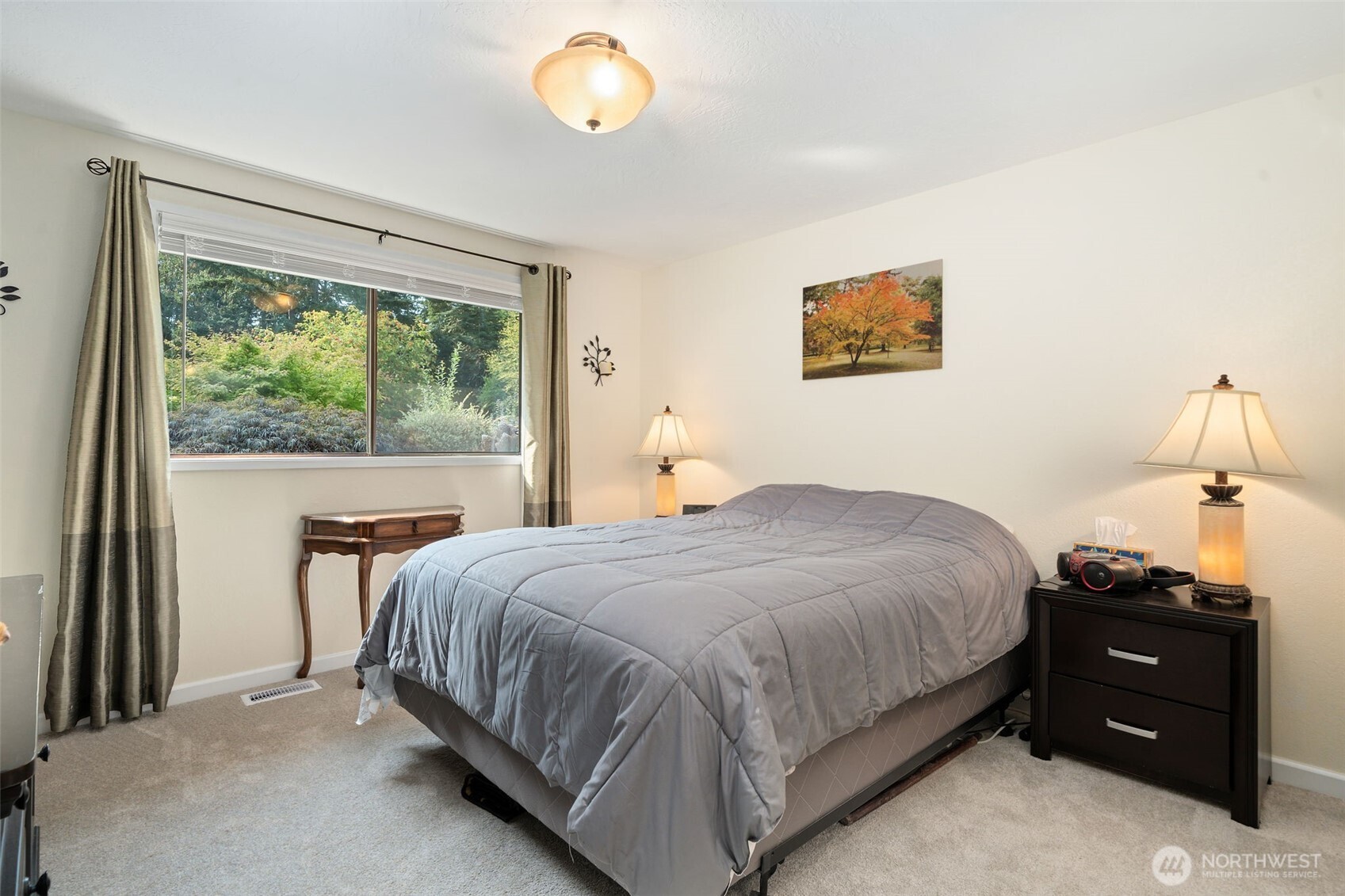 383 Kirner Road Sequim, WA 98382 - Photo 24 of 40 a bedroom with a bed and a lamp next to a window