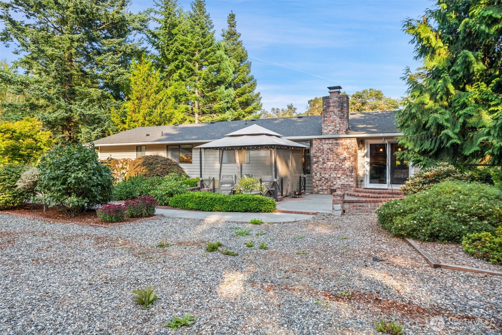 383 Kirner Road Sequim, WA 98382 - Photo 27 of 40 a front view of a house with a garden and plants
