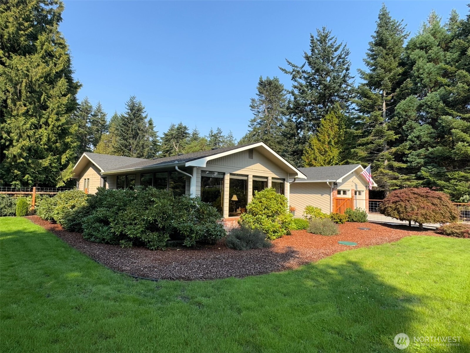 383 Kirner Road Sequim, WA 98382 - Photo 40 of 40 a front view of a house with a yard and potted plants