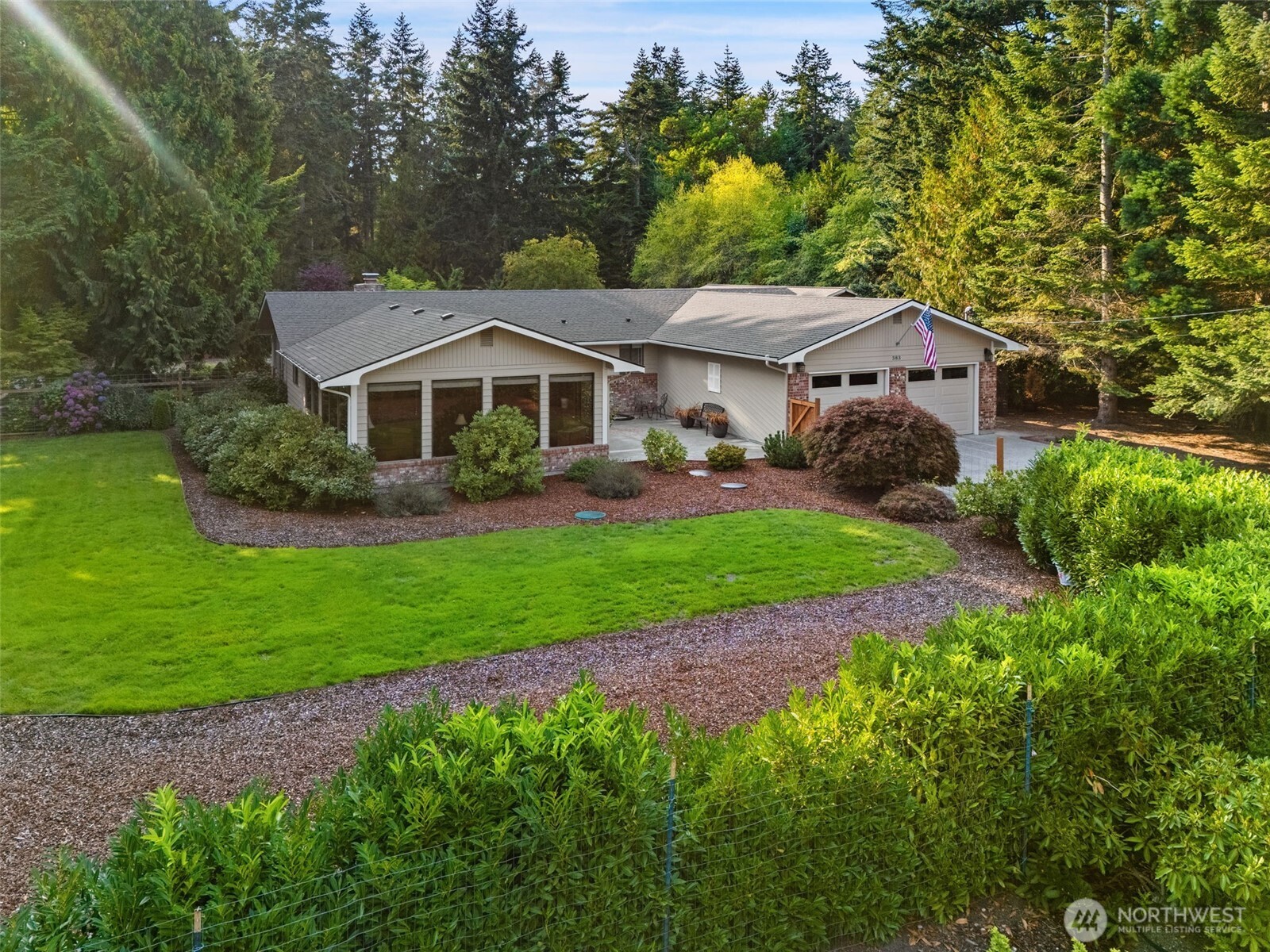 383 Kirner Road Sequim, WA 98382 - Photo 4 of 40 a front view of a house with a garden