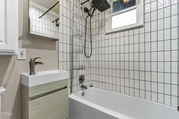 a bathroom with a bathtub and shower