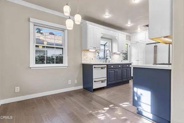 a kitchen with granite countertop a stove a sink and a window