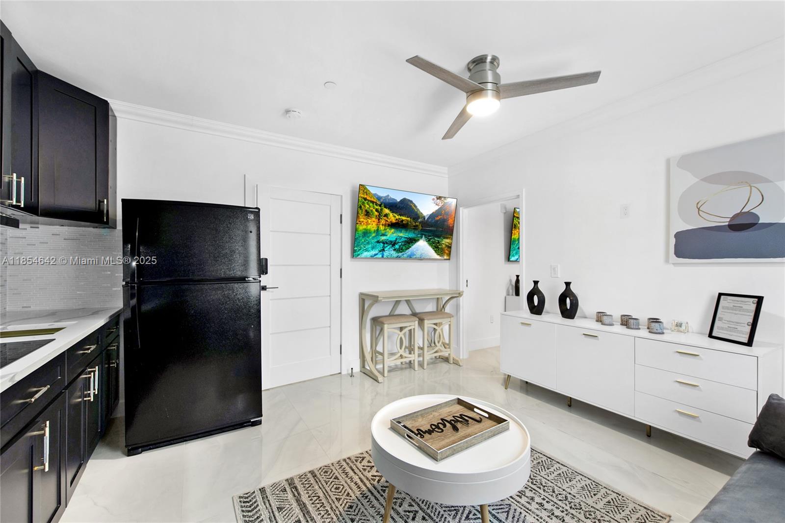 91865 Overseas Highway, Unit 104 Tavernier, FL 33070 - Photo 2 of 6 a living room with furniture and a flat screen tv