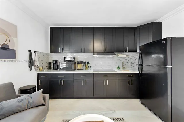 a kitchen with stainless steel appliances granite countertop a refrigerator sink and cabinets