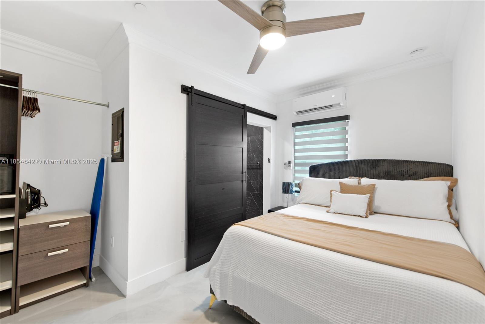 91865 Overseas Highway, Unit 104 Tavernier, FL 33070 - Photo 5 of 6 a bedroom with a bed and a flat tv screen