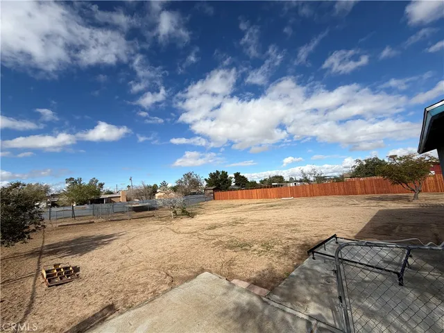 a view of house and outdoor space with wooden fence