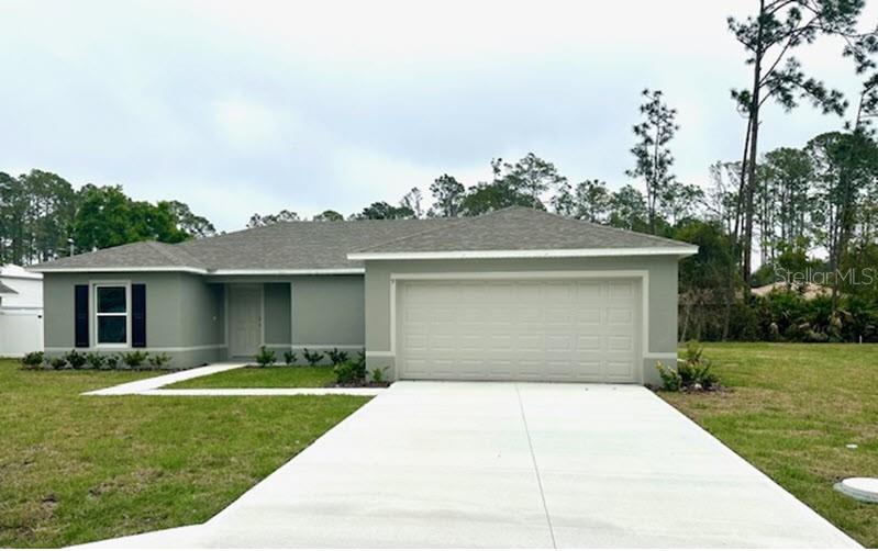 9 Ripton Place Palm Coast, FL 32164 - Photo 2 of 14 a house view with a garden space
