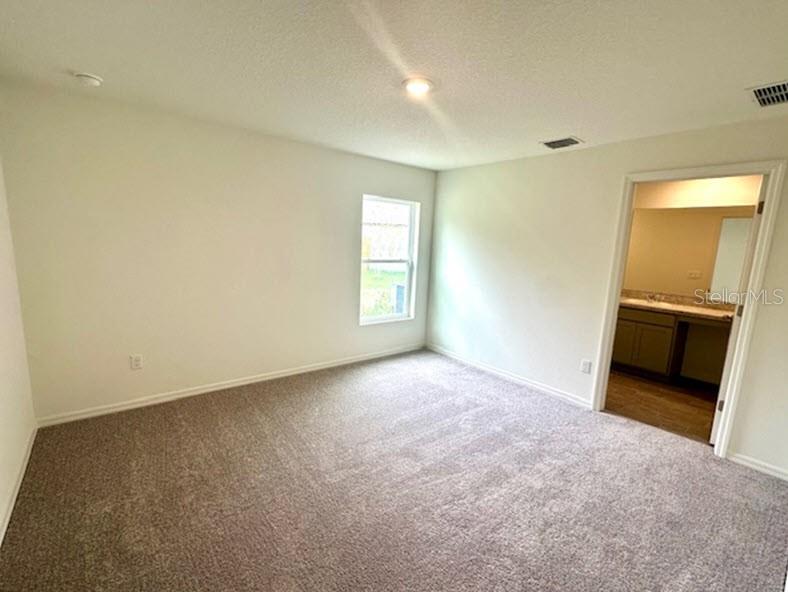 9 Ripton Place Palm Coast, FL 32164 - Photo 6 of 14 an empty room with windows and a fireplace
