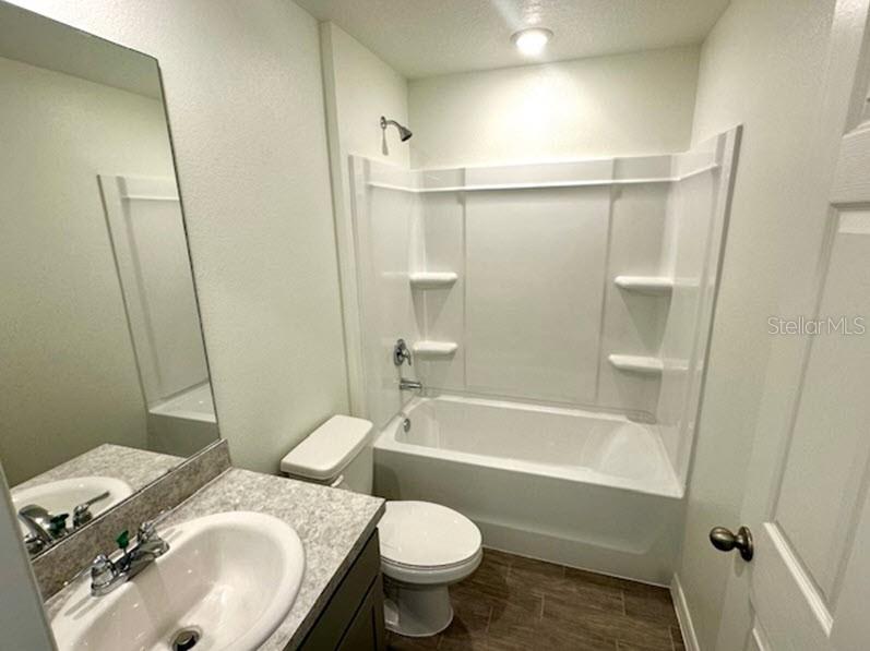 9 Ripton Place Palm Coast, FL 32164 - Photo 9 of 14 a bathroom with a sink toilet and shower