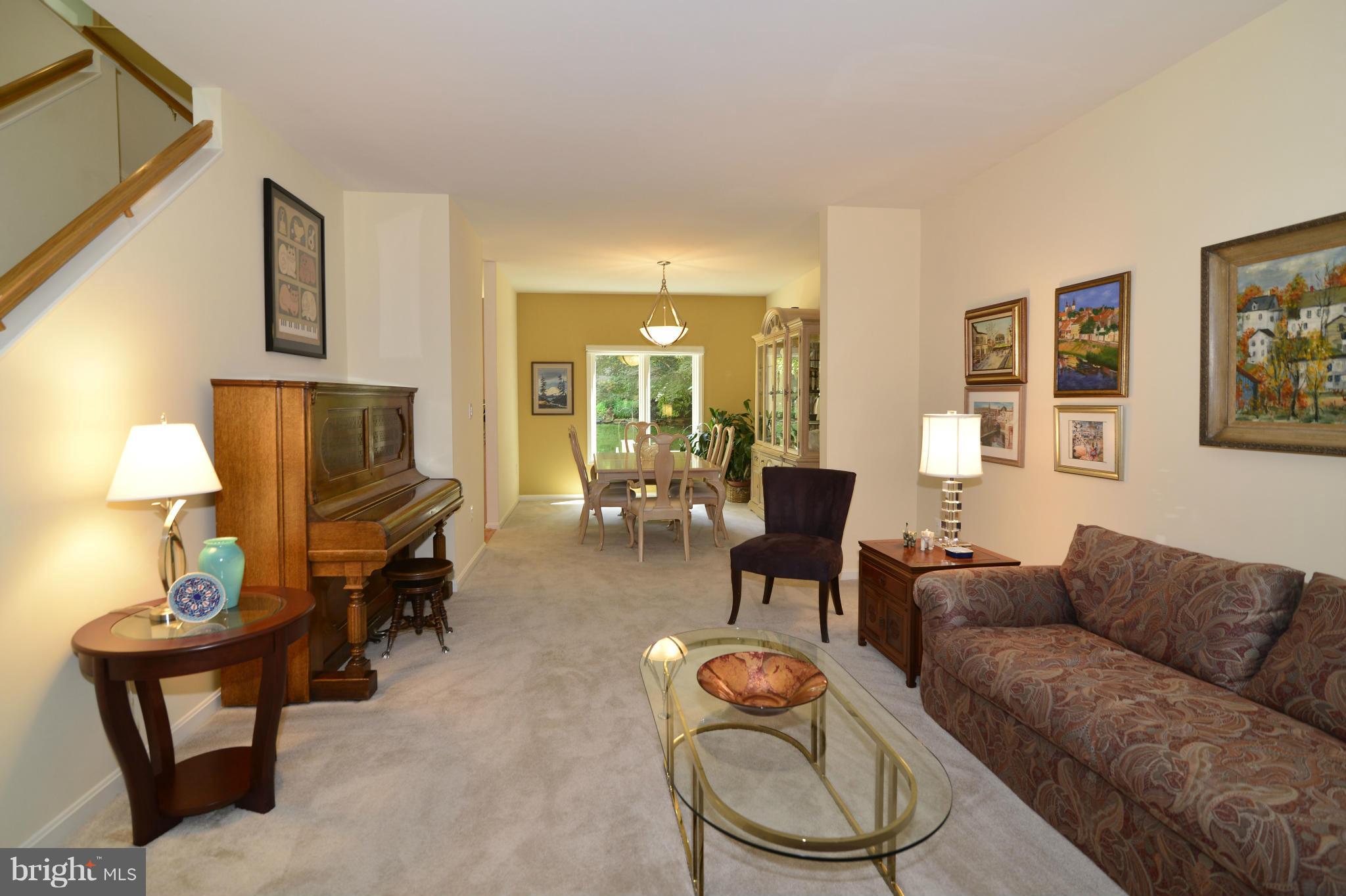 2015 Beacon Place Reston, VA 20191 - Photo 11 of 22 a living room with furniture a lamp and a flat screen tv