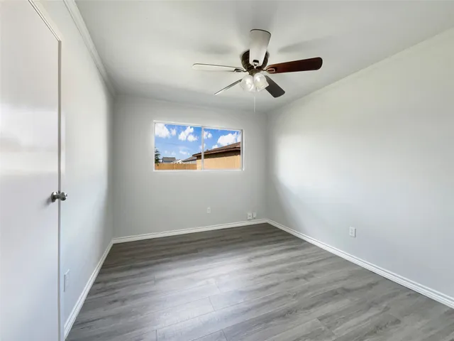 a view of a big room with wooden floor closet and windows