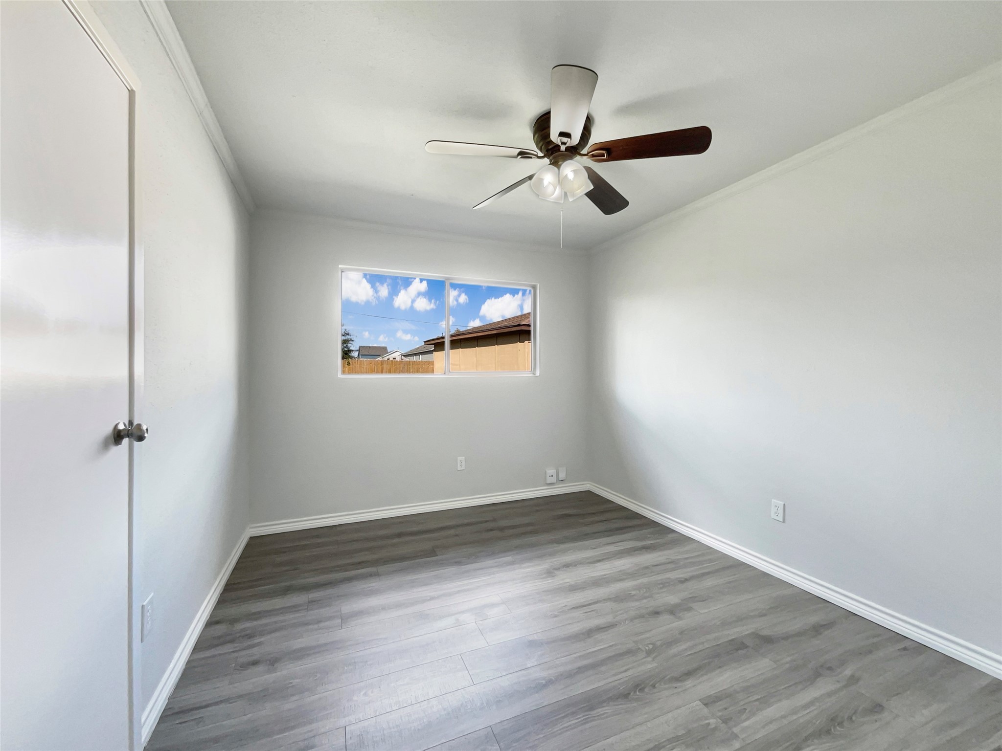 205 Bastrop Street Angleton, TX 77515 - Photo 11 of 18 a view of a big room with wooden floor closet and windows