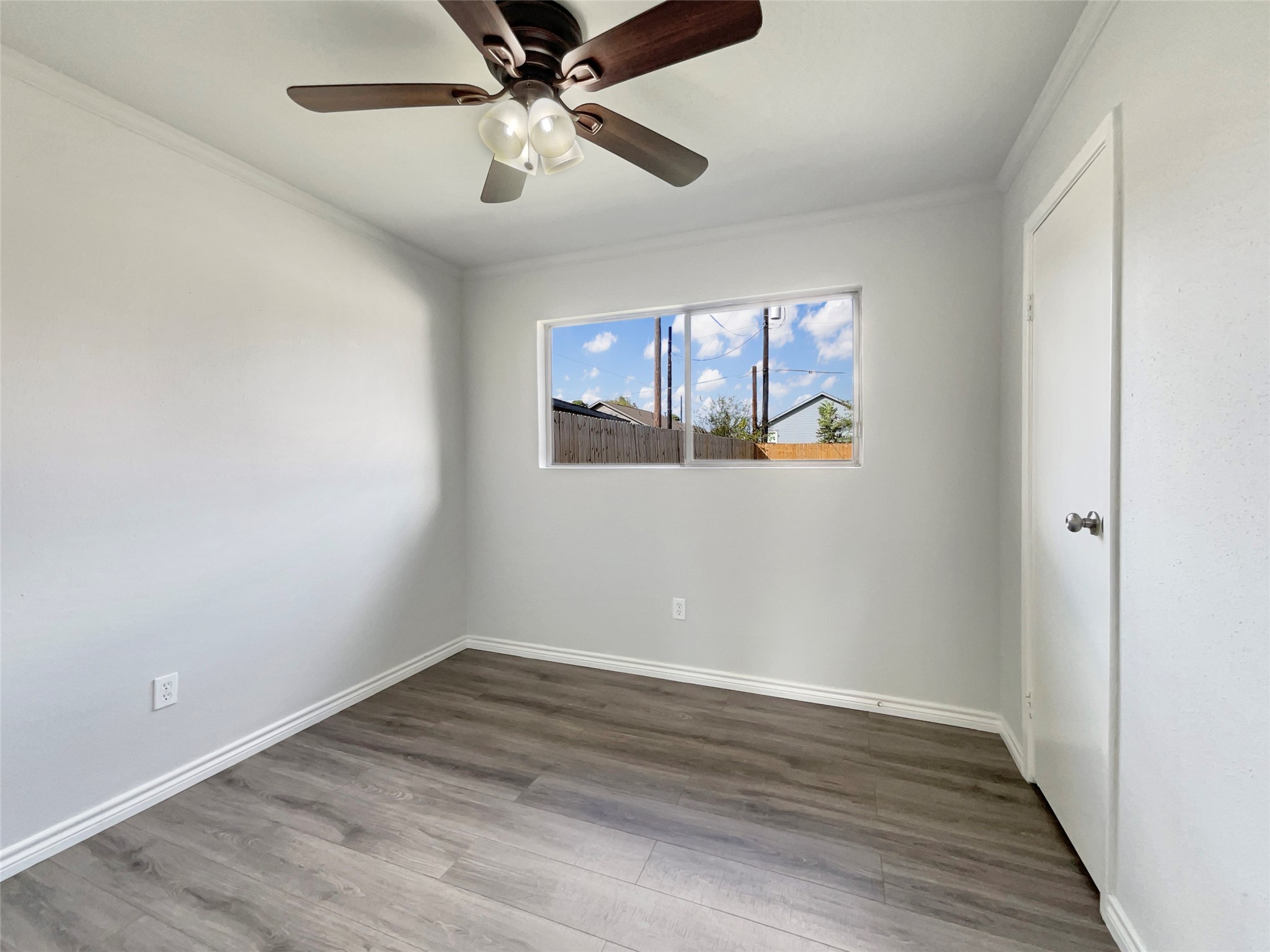205 Bastrop Street Angleton, TX 77515 - Photo 12 of 18 wooden floor in an empty room with a window
