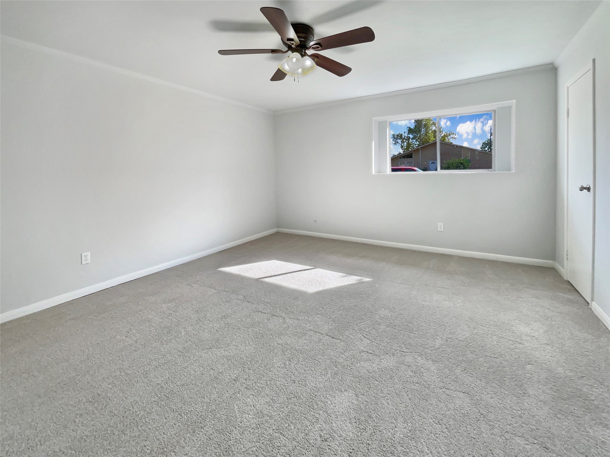 205 Bastrop Street Angleton, TX 77515 - Photo 13 of 18 an empty room with windows and fan view